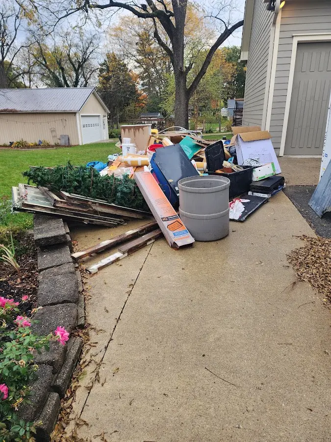 Dumpster being loaded with debris for Estate Cleanout Dumpster Rental in Leon Valley